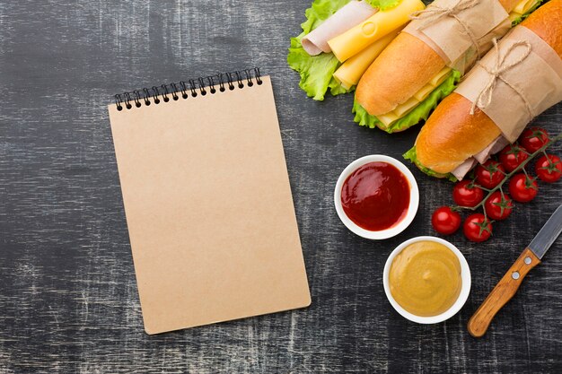 Empty notepad and sandwiches