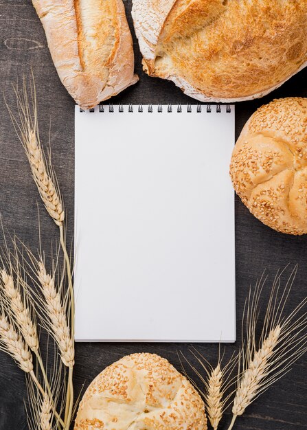 Empty notepad surrounded by bread