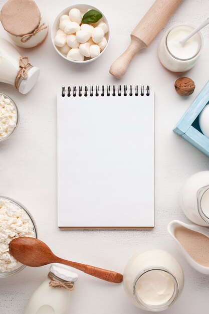 Empty notepad surrounded by dairy products