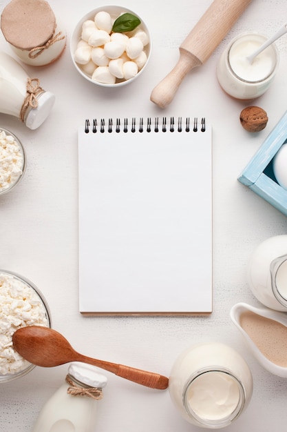 Empty notepad surrounded by dairy products