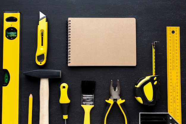 Empty notepad and yellow repair tools with copy space