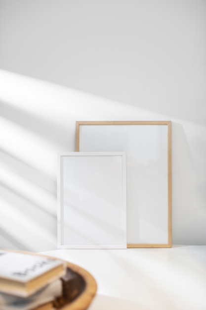 Empty photo frames and books interior design