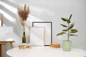 Free photo empty photo frames on table arrangement