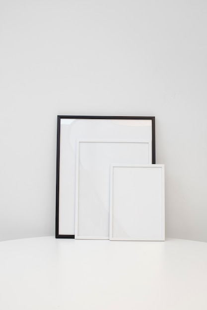 Empty photo frames on white table