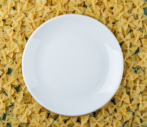 Empty plate on farfalle pasta