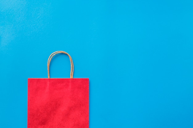 Empty red shopping bag on blue background