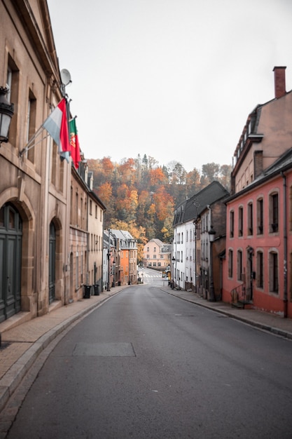 Empty road between red and brown concrete buildings