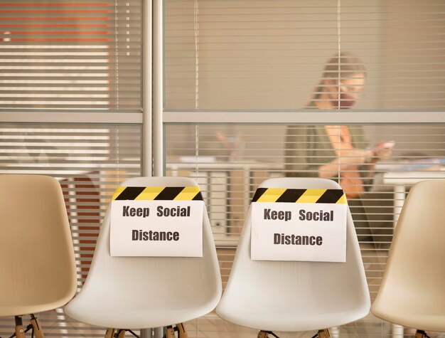 Empty seats with social distance sign at work