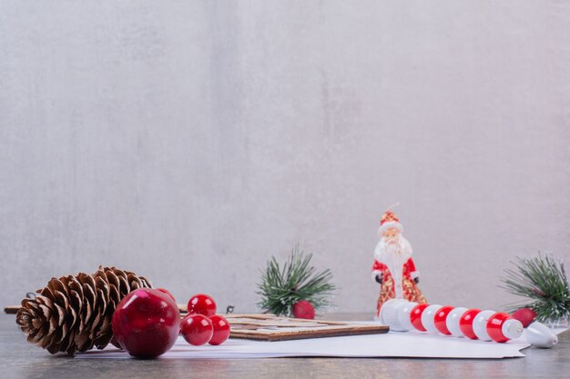 Empty sheets of paper with Christmas decoration on stone surface