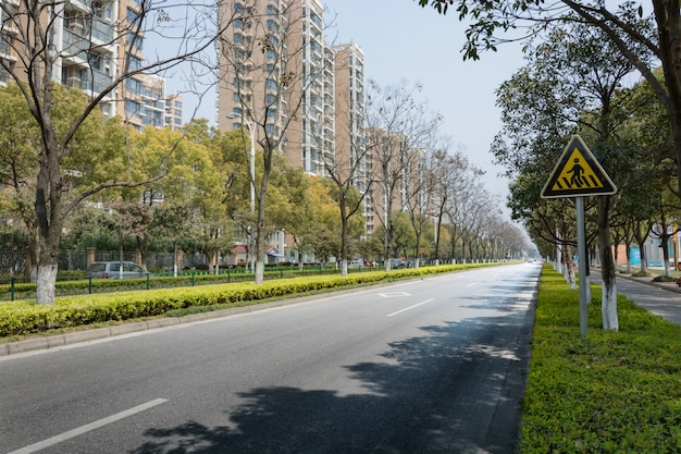 Empty street with buildings and trees