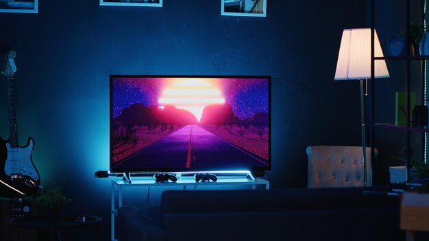 empty stylish neon lit home studio interior illuminated with neon lights at night and artwork