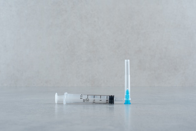 Empty syringe closeup isolated on gray background. High quality photo