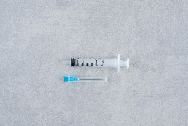 Empty syringe closeup isolated on gray