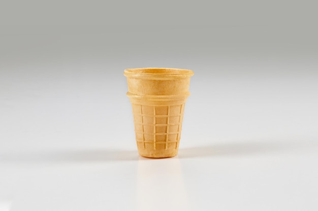 Empty, toasty wafer cup for ice cream isolated on white. concept of food, treats. mockup, template for your advertising and design. close up