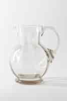 Free photo empty transparent glass jug on gray