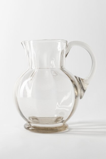 Empty transparent glass jug on gray