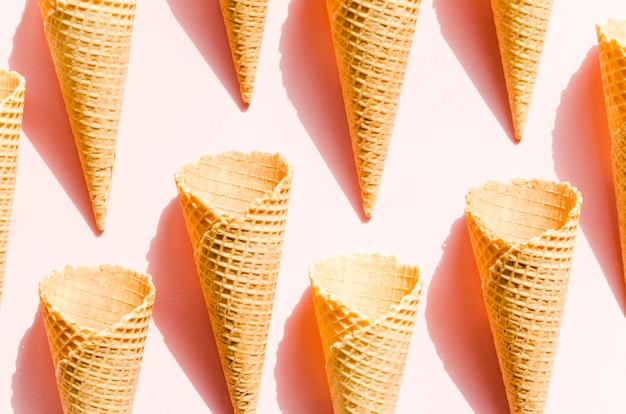 Empty waffle cones scattered on pink table