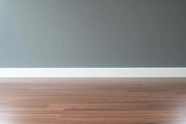 empty wall with a wooden floor below