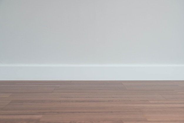 empty wall with a wooden floor below