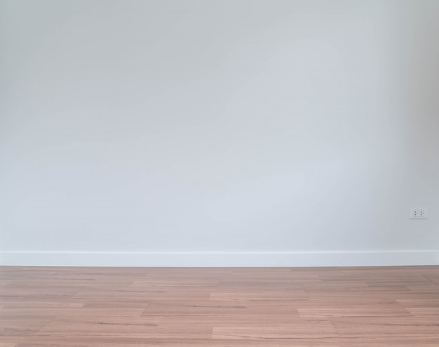Empty wall with a wooden floor below