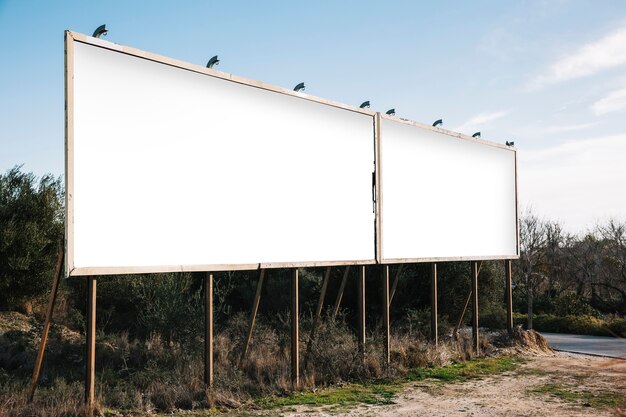 Empty white billboards on suburban roadside