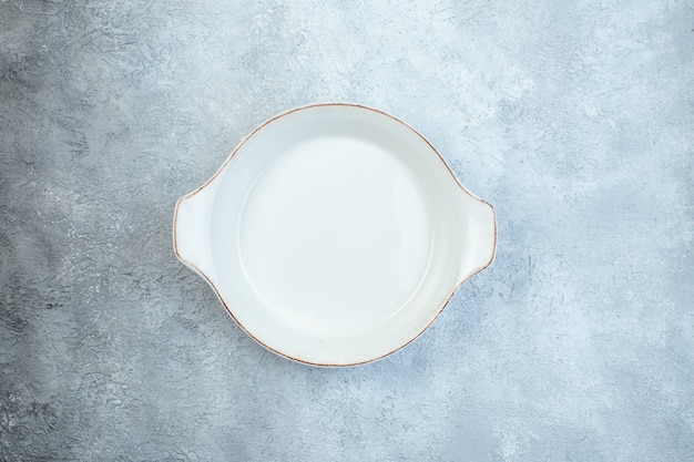 Empty white soup plate on gray surface with distressed surface with free space