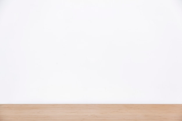 Free photo empty white wall and wooden surface