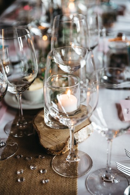 Empty wineglasses and other serving details stand on a holiday table