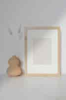 Free photo empty wooden frame with dried flowers in a gourd vase