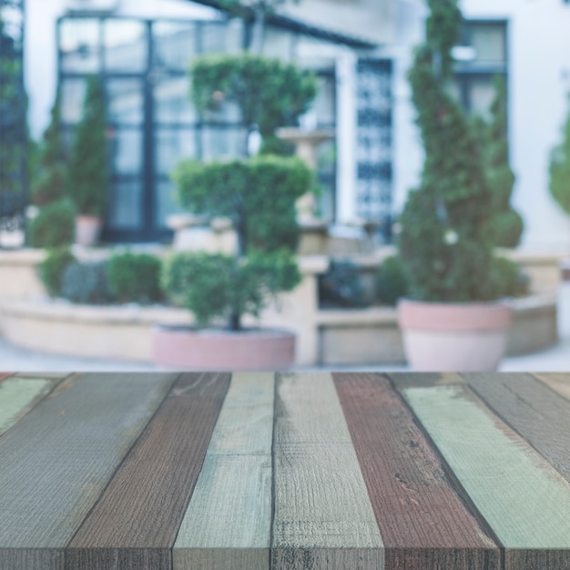 Empty wooden table in front of house