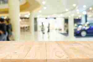 Free photo empty wooden table space platform with blurred shopping mall or shopping center background for product display montage. wooden desk with copy space.