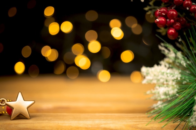 Empty wooden table with blurred christmas lights and decorations. free space for montage, mockup for product designs