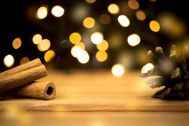 Empty wooden table with christmas lights and cinnamons. happy new year and holiday concept. blank space for montage product placement display photo