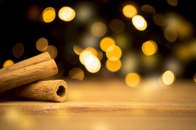 Empty wooden table with christmas lights and cinnamons. happy new year and holiday concept. blank space for montage product placement display photo