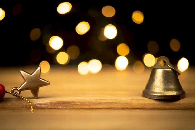 Empty wooden table with christmas lights and decoration, golden sparkles and bokeh. holiday and new year background, free space for your design or products