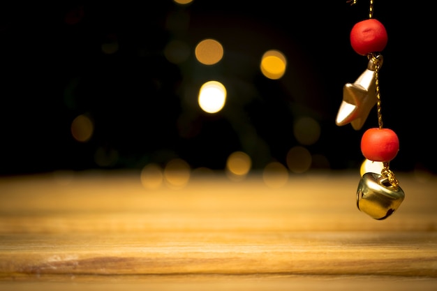 Empty wooden table with christmas lights, golden sparkles and bokeh. holiday and new year background, free space for your design or products