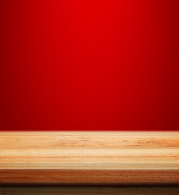 Empty wooden table with red christmas background for product placement with blur christmas wallpaper background