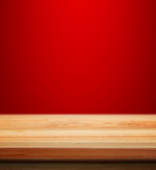 Empty wooden table with red christmas background for product placement with blur christmas wallpaper background