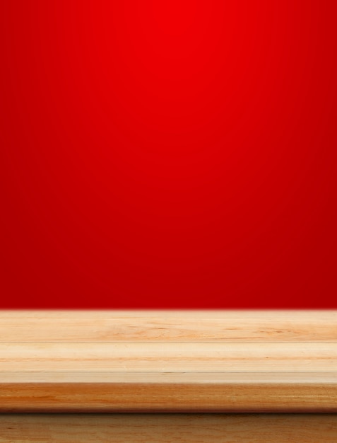 Empty wooden table with red christmas background for product placement with blur christmas wallpaper background