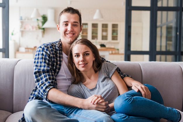 Enamored couple bonding on sofa