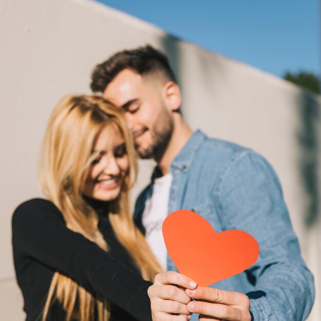 Enamored couple with red heart