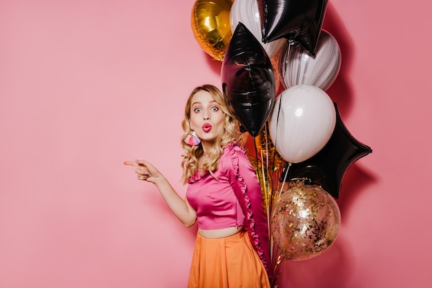 Enchanting curly woman having fun at party