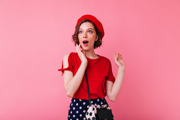 Enchanting white girl with tattoo looking at something. Portrait of gorgeous french woman in beret isolated.