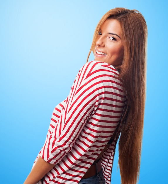 Endearing girl smiling over shoulder