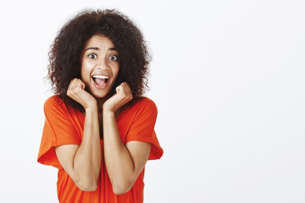 energetic woman with afro hairstyle posing in the studio