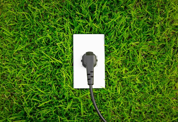 Energy concept outlet in fresh spring green grass