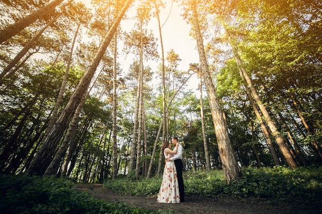 Engaged couple in a summer forest
