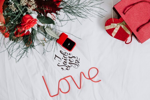 Engagement ring among presents and love writing