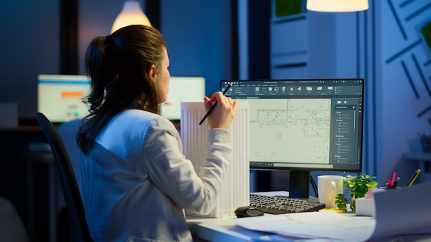 Engineer constructor designer architect creating new component in CAD program working in business office. Industrial woman employee studying prototype idea showing cad software on device display