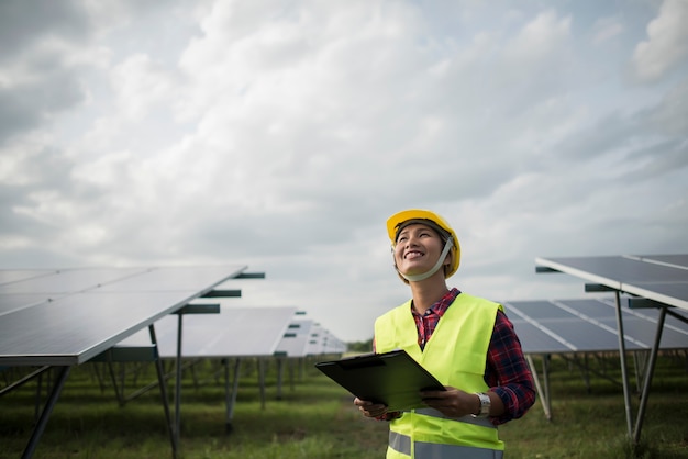 Engineer electric woman checking and maintenance of solar cells.